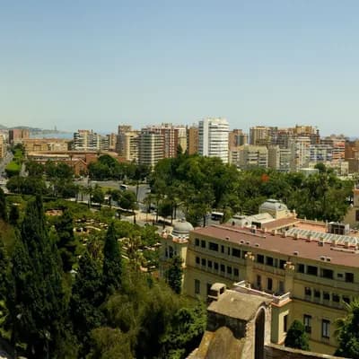 View across Málaga towards the harbour, with the bullring in the foreground